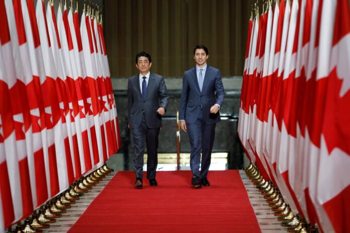 Prime Minister Trudeau and Prime Minister Abe walk to the Sir John A MacDonald Building in Ottawa.