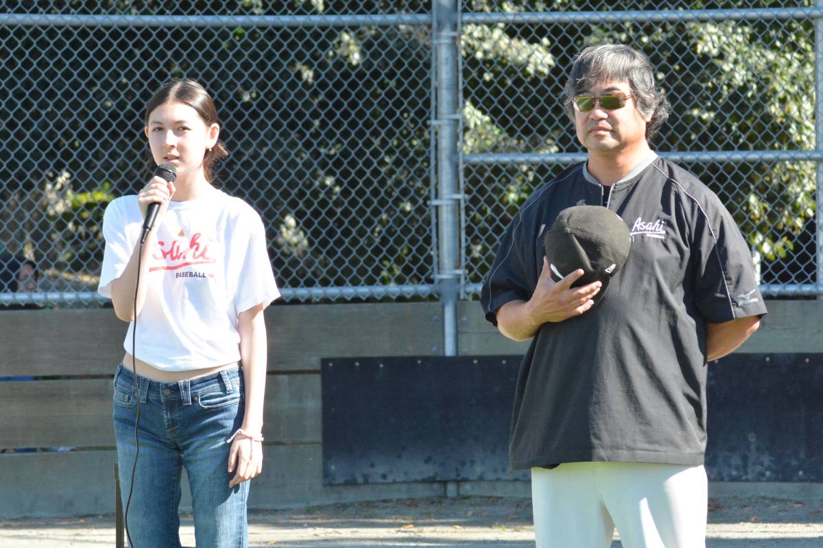 国会斉唱はTamika Robertsさん（左）。隣りはJohn Wong会長。2022年9月5日、バンクーバー市ナナイモパーク。写真：Noriko Tsuchiya/The Asahi Baseball Association