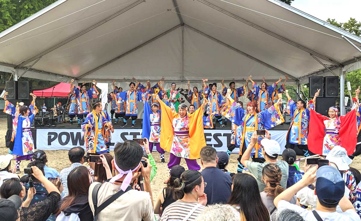高知県よさこいアンバサダー絆国際チームのパフォーマンス。多くの観衆がカメラを構える。2023年8月6日、バンクーバー市オッペンハイマー公園。Photo by Japan Canada Today