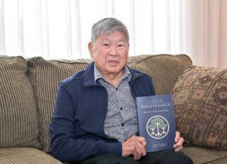 アート・ミキさん「Gaman – Perseverance: Japanese Canadians’ Journey to Justice」出版 アート・ミキさん。著書「Gaman」を手に。2024年4月、リッチモンド市で。撮影 斉藤光一