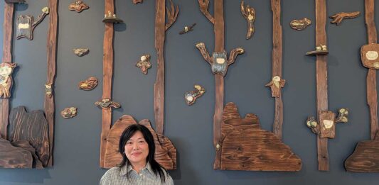 アーティストの望月シンディーさん、作品「Arboreal Time」とともに。2025年9月19日、バーナビー市。撮影　古川紋／日加トゥデイ