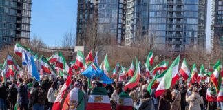 バンクーバーのイラン系コミュニティ、米国のイラン攻撃に歓喜 バンクーバー市デイビッド・ラム公園に集まったイラン系カナダ人コミュニティの人たち。太陽と剣を持つ獅子の紋章が中央に描かれた国旗が多く見られた。2026年3月1日、バンクーバー市。撮影 日加トゥデイ